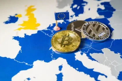 Monedas físicas con logos de criptomonedas arriba de un mapa europeo.